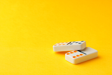 Domino tiles on yellow background studio shot