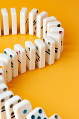 Row of domino tiles on yellow studio background