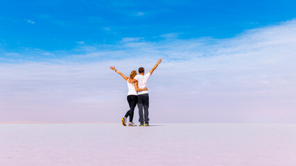 Happy couple on salt flats beach, paradise vacation, serenity, wellness concept(Turkey,   Ankara, salt lake, Tuz Gölü )