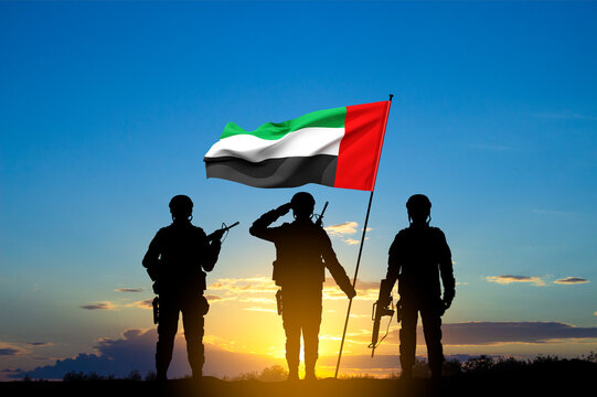 Silhouettes of soldiers with the flag of UAE against the sunset. Armed forces of United Arab Emirates. Concept for Commemoration Day, Martyrs Day, National Day.. 3d-rendering