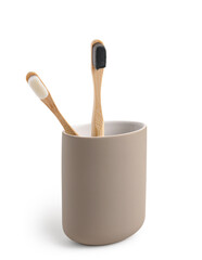 Bamboo tooth brushes in holder on white background