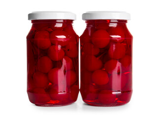 Jars of canned maraschino cherries on white background