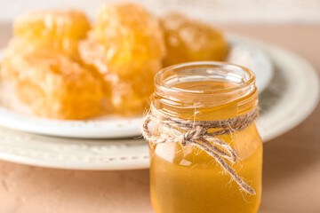 Jar with sweet honey on table