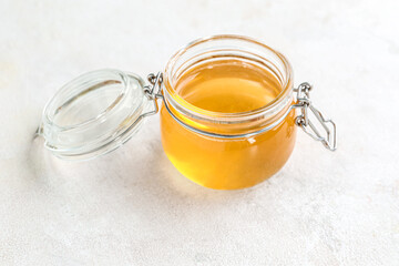 Jar with sweet honey on white background