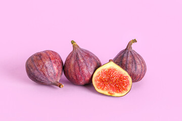 Fresh juicy cut figs on lilac background