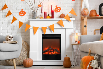 White fireplace with Halloween decorations and garland in festive living room