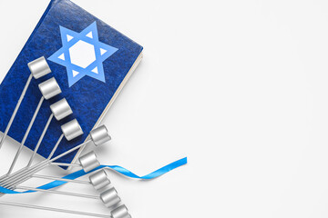 Hanukkah composition with Torah, David star and menorah on white background