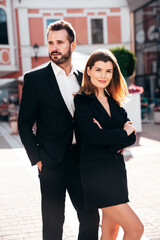  Beautiful fashion woman and her handsome elegant boyfriend in black suit. Sexy brunette model in jacket. Fashionable smiling couple posing in street. Brutal man and female outdoors