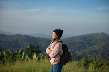woman traveler wanderer wearing hat stand alone and enjoying freedom and calm inspired travelling....