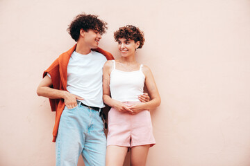 Young smiling beautiful woman and her handsome boyfriend in casual summer clothes. Happy cheerful...