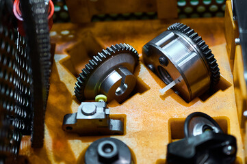 Various parts for assembly during the assembly of an automobile engine. A variety of pulleys,...