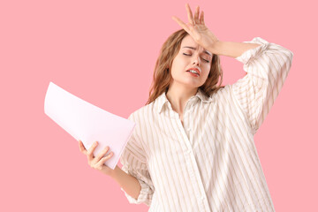 Beautiful actress with film script on pink background