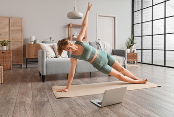 Young woman doing yoga at home - obrazy, fototapety, plakaty