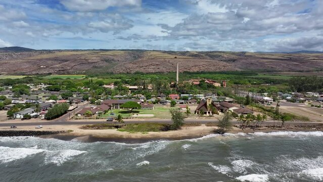 Aerial Kauai Hawaii Waimea beach church factory slide 1. Old abandoned derelict Sugar Mill. Rusty building and equipment. Sugar cane was a dominate industry in the islands. Economy is now tourism.