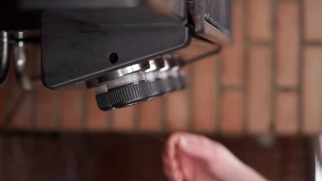 Man turn on gas barbecue grill burners with control knobs.