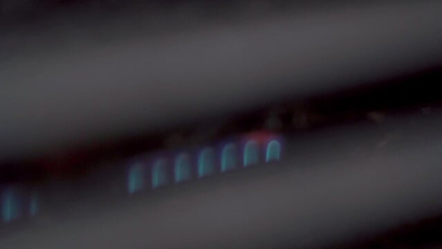 Close-up of a gas grill with igniting flames inside