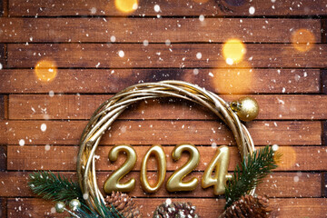 Happy New Year wooden numbers 2024 on cozy festive brown wooden background with sequins, snow,...