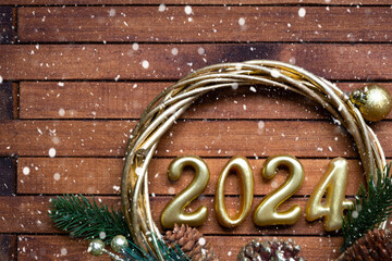 Happy New Year wooden numbers 2024 on cozy festive brown wooden background with sequins, snow,...