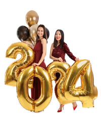 Female friends with figure 2024 and balloons on white background. New Year celebration