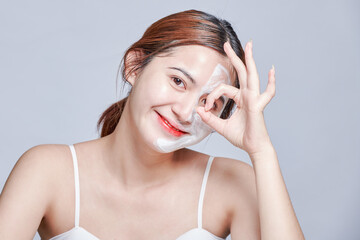 Spa girl applying facial mask. Beauty treatments mask with collagen, hyaluronic acid for glowing...