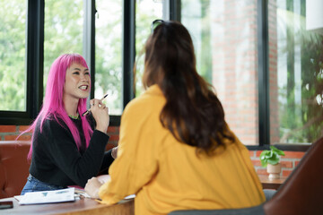 Asian transgender Pink Hair Business People Meeting Design Ideas for new start up project working together meeting business plan listen coworker and discussing team work Gender equality LGBTQ+ concept - obrazy, fototapety, plakaty