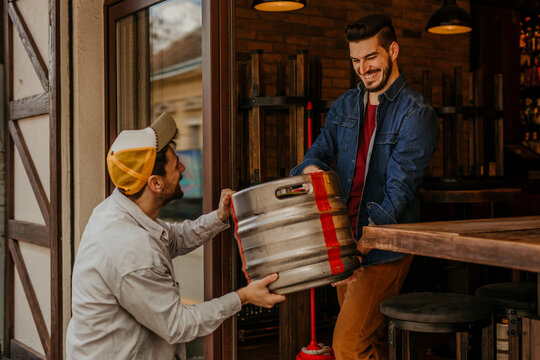 A shot captures the restaurant worker inspecting the quality of the received drinks, ensuring that all items meet the established standards before being accepted into the inventory.
