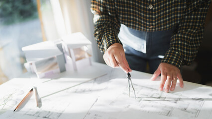 Engineer or interior Architects designer construction plans on blueprint.
