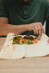 Man cooking homemade falafel meal.
