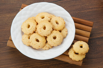 Kue Keju or Cheese cookies. Served on white plate

