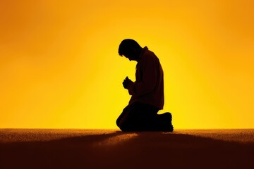 Christian prayer. Man on his knees praying on sunset background. Kneeling prayer to God. Worship and praise.