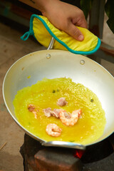 Female hand making banh xeo at home