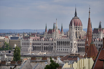 Fototapeta premium View on Hungarian Parliament Building (Hungarian: Országház) from a Fisherman's Bastion hill across Danube river. Budapest, Hungary - 7 May, 2019