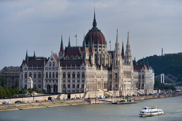 Fototapeta premium The most popular tourist landmark in Budapest, Hungarian Parliament Building (Hungarian: Országház) on bank of river Danube. Budapest, Hungary - 7 May, 2019