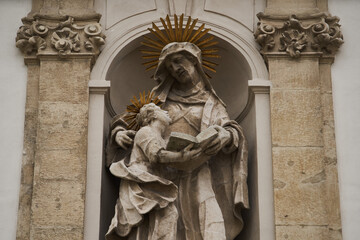 Statue of Saint Anne with a Virgin Mary on a church facade (Hungarian: Felsővízivárosi Szent Anna-plébánia). Budapest, Hungary - 7 May, 2019