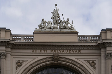 Fototapeta na wymiar Keleti railway station (Hungarian: Keleti Palvaudvar) entrance arch decorated with statues. Budapest, Hungary - 7 May, 2019