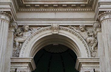 Stone arch of Varkert Bazar (Hungarian: Várkert Bazaar or Várbazár) decorated with columns and angels sculptures. Budapest, Hungary - 7 May, 2019