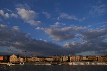 Fototapeta premium Beautiful panorama of Budapest waterfront on Danube river at sunset. Budapest, Hungary - 7 May, 2019