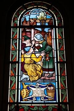 Saint Honore d'Eylau church, Paris, France. Stained glass. St. Zite giving water to the poor, miraculously turned into wine.