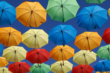 Colorful umbrellas over the main street in L' Aigle, Orne, France