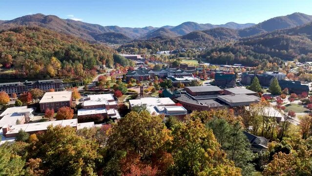 slow aerial push over treetops in fall to western carolina university