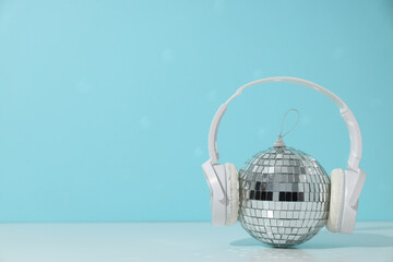 Fototapeta na wymiar A beautiful disco ball with headphones on a blue background
