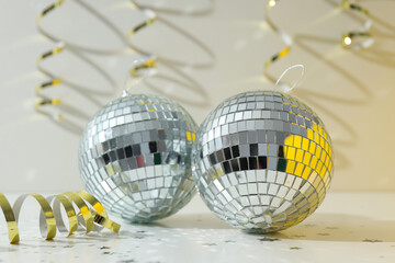 Disco balls with festive golden ribbons on the background