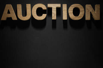 Wooden letters on black background, space for text