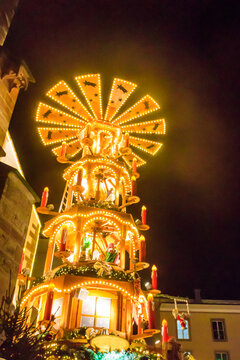 Traditional spinning  Christmas pyramid lit up at night, at Christmas market in Basel, Switzerland