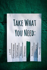 Tear-off stub note with text 'Take what you need' on emerald background. One wish is torn off.