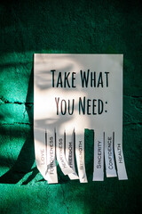Tear-off stub note with text 'Take what you need' on emerald background. One wish is torn off.