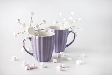 Hot cocoa with marshmallows in purple mug with snowflake. Handmade marshmallows snowflake.