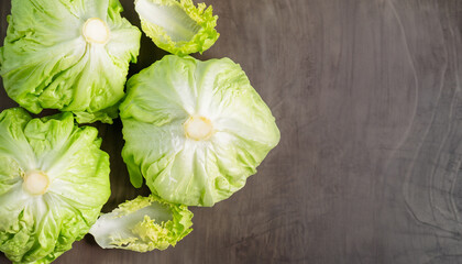 Raw Organic Round Crisp Iceberg Lettuce Ready to Eat; top view with copy space - obrazy, fototapety, plakaty