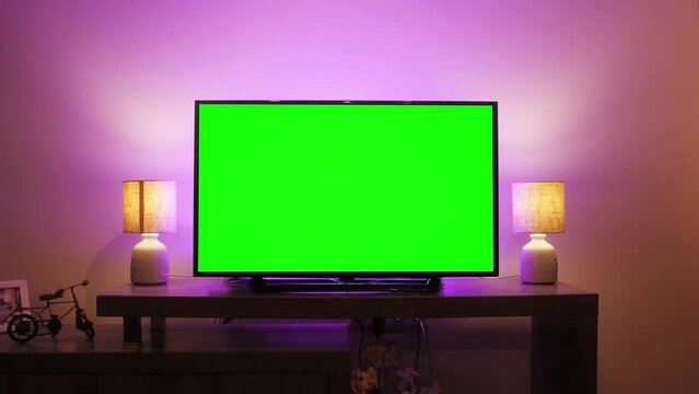 LcD smart TV screen with a blank green background in the living room. Chroma key screen for advertising.