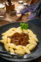 Beef stew in gravy, served with potato dumplings.